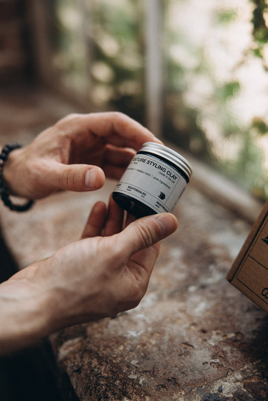 hair clay jar in man's hands